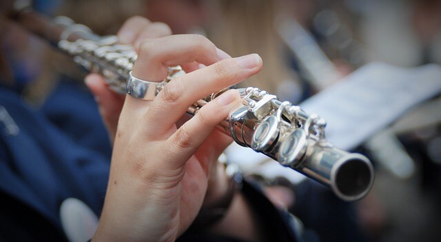 A person playing the flute at an orchestral performance
